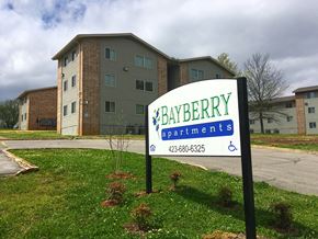 Chattanooga apartment for rent - a building with a sign in the grass in front of it