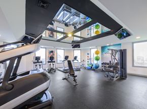 Westerville townhouse for rent - a gym with treadmills and other exercise equipment and windows