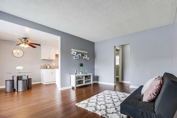 West Covina apartment for rent - A living room with a black couch and a white rug.