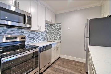 Redwood City apartment for rent - a kitchen with stainless steel appliances and white cabinets