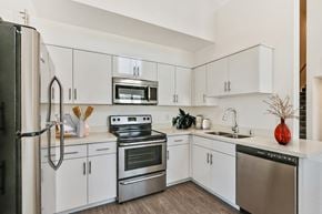 Glendale apartment for rent - A modern kitchen with white cabinets and stainless steel appliances.