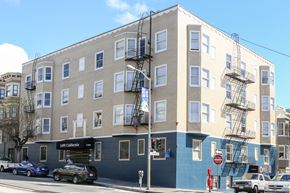 San Francisco apartment for rent - an apartment building on the corner of a street with cars parked