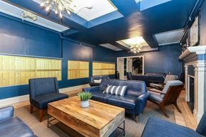 San Francisco apartment for rent - a lobby with blue walls and leather furniture and a wooden table