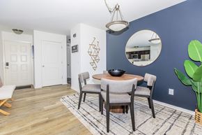 West Bloomfield apartment for rent - a dining room with a table and chairs and a blue wall