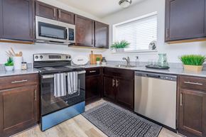 West Bloomfield apartment for rent - a kitchen with stainless steel appliances and wooden cabinets