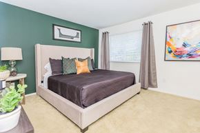 West Bloomfield apartment for rent - a bedroom with a bed and a large window