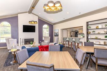 West Bloomfield apartment for rent - a living room with a table and chairs and a fireplace