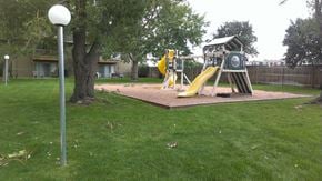 Arvada apartment for rent - a playground with a swing set in a park