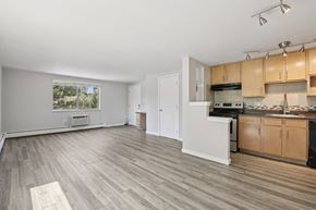 Denver apartment for rent - A kitchen with wooden cabinets and a white countertop.