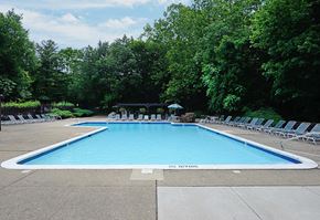 Springfield apartment for rent - a swimming pool with white chairs around it