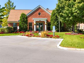Bowling Green apartment for rent - the front of a red brick house with a driveway and trees