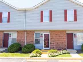 Grove City apartment for rent - A grey house with red doors and windows.