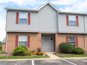 Grove City apartment for rent - A two-story house with red shutters on the windows.