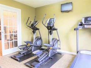 Butler apartment for rent - a gym with several machines and a television