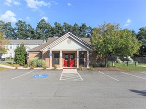 Butler apartment for rent - the front of a building with a parking lot and a red door