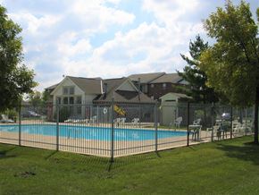 Hilliard apartment for rent - a swimming pool in front of a house behind a fence