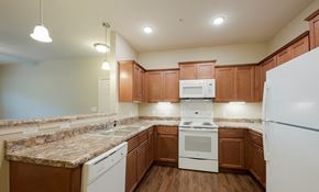 Nashville apartment for rent - a kitchen with white appliances and granite counter tops