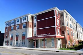 Cleveland apartment for rent - A multi-story building with a red and white facade and a sign that reads "A PLACE FOR US".