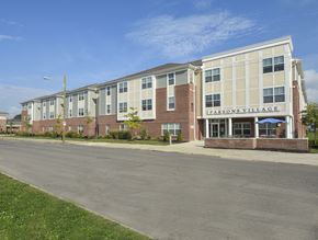 Columbus apartment for rent - A large brick building with the words "LARSON'S VILLAGE" on the front.