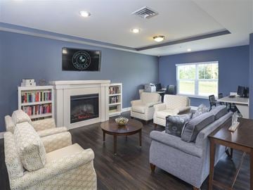 Findlay apartment for rent - A living room with a fireplace and a television mounted above it.