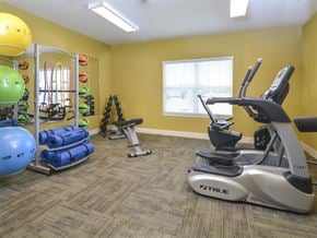 Findlay apartment for rent - A gym room with a treadmill, exercise balls, and other equipment.