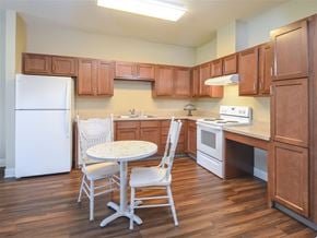 Findlay apartment for rent - A kitchen with wooden cabinets and a white refrigerator.