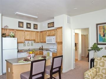 Corpus Christi apartment for rent - A kitchen with a table and chairs in front of it.