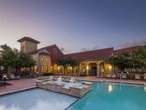 Corpus Christi apartment for rent - A pool with a fountain in the middle of it.