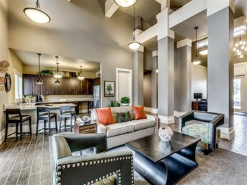 San Antonio apartment for rent - A modern living room with a black leather couch and a wooden coffee table.