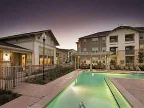 Fort Worth apartment for rent - A swimming pool in front of apartment buildings.