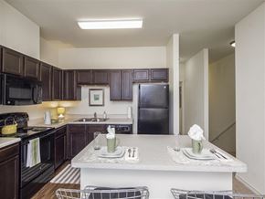 San Antonio apartment for rent - a kitchen with black appliances and a white counter top