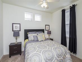 San Antonio apartment for rent - a bedroom with a bed and a ceiling fan