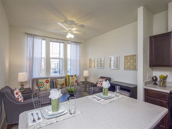 San Antonio apartment for rent - a living room with a table and a ceiling fan