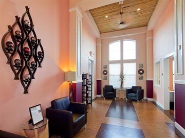 Houston apartment for rent - A living room with a black couch and a wooden table.