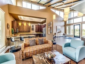 San Antonio apartment for rent - A living room with a patterned sofa and a coffee table with a bowl of fruit on it.