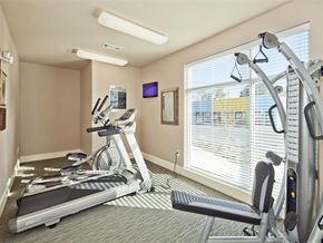 Fort Worth apartment for rent - A gym room with a treadmill, a stationary bike, and a rowing machine.