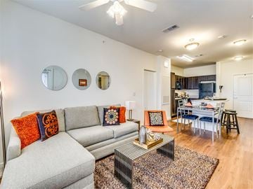 Dallas apartment for rent - A living room with a grey couch and a coffee table.