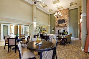 San Antonio apartment for rent - A large dining room with a dark wood table surrounded by chairs.