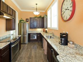 Karnes City apartment for rent - A kitchen with a refrigerator, oven, microwave, and sink.
