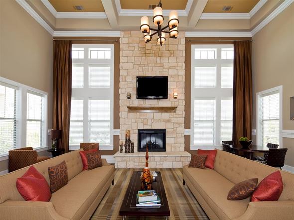 Fort Worth apartment for rent - A living room with a fireplace and a television mounted above it.