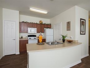 Fort Worth apartment for rent - A kitchen with a white counter and a white fridge.