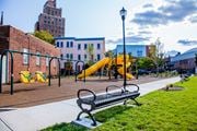 Newark apartment for rent - a playground with a bench and slides in a park