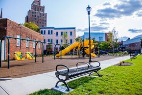 Newark apartment for rent - a playground with a bench and slides in a park