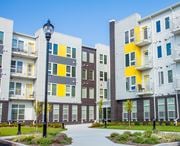 Newark apartment for rent - a group of modern apartment buildings with a sidewalk