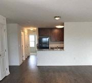 Flemington apartment for rent - an empty living room and kitchen with a black refrigerator