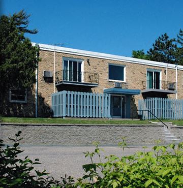 St Paul apartment for rent - a brick building with a white fence in front of it