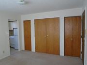 St Paul apartment for rent - an empty living room with three doors and a kitchen