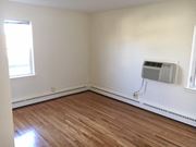 St Paul apartment for rent - an empty room with wood floors and an air conditioner
