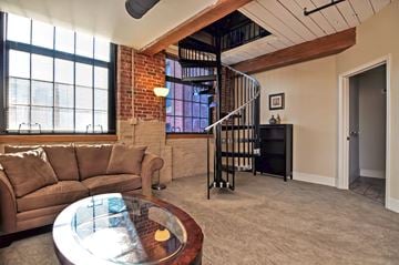 Providence apartment for rent - a living room with a couch and a spiral staircase