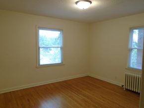 St Paul apartment for rent - an empty room with a wood floor and two windows